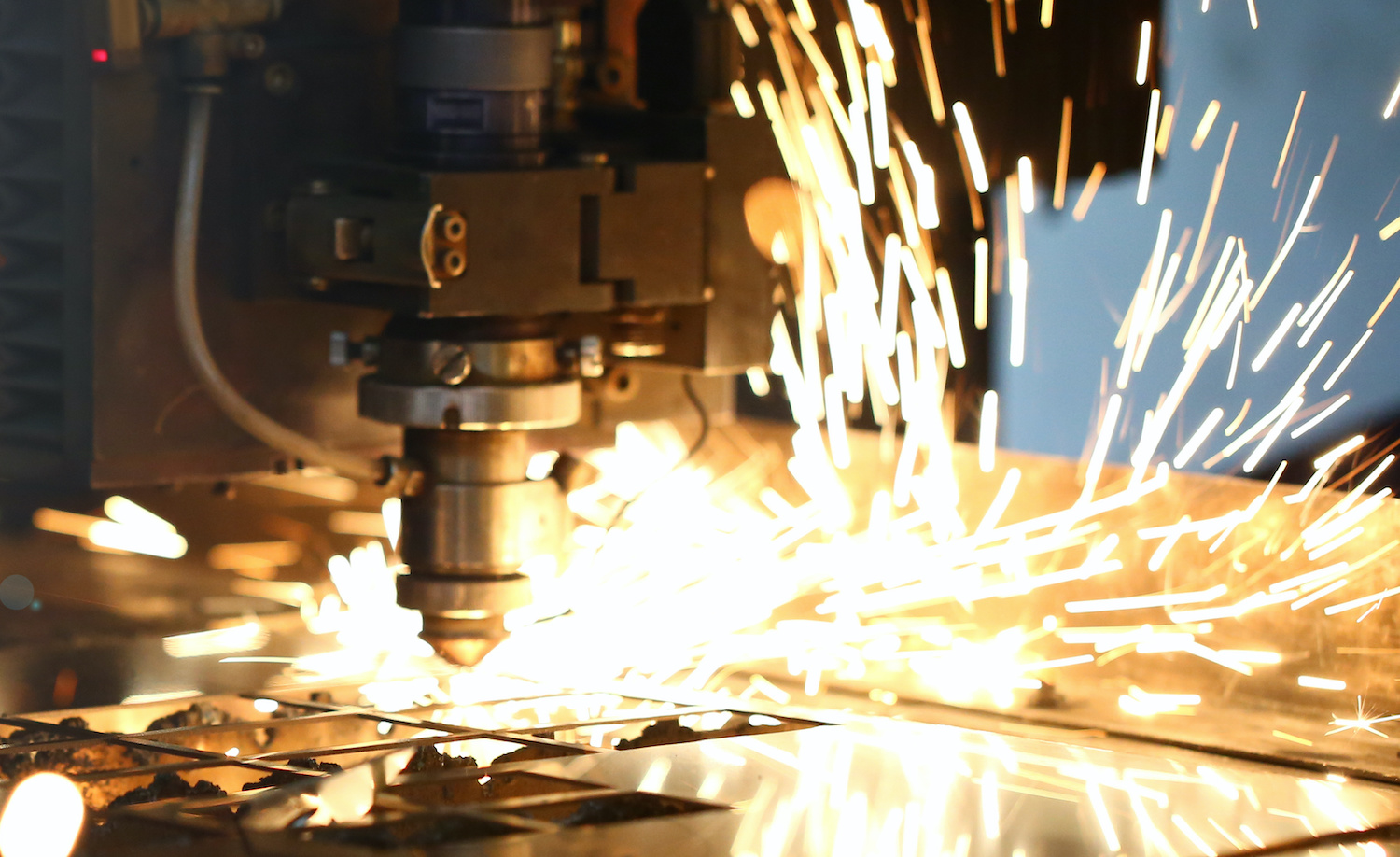 Sparks fly out of a manufacturing machine