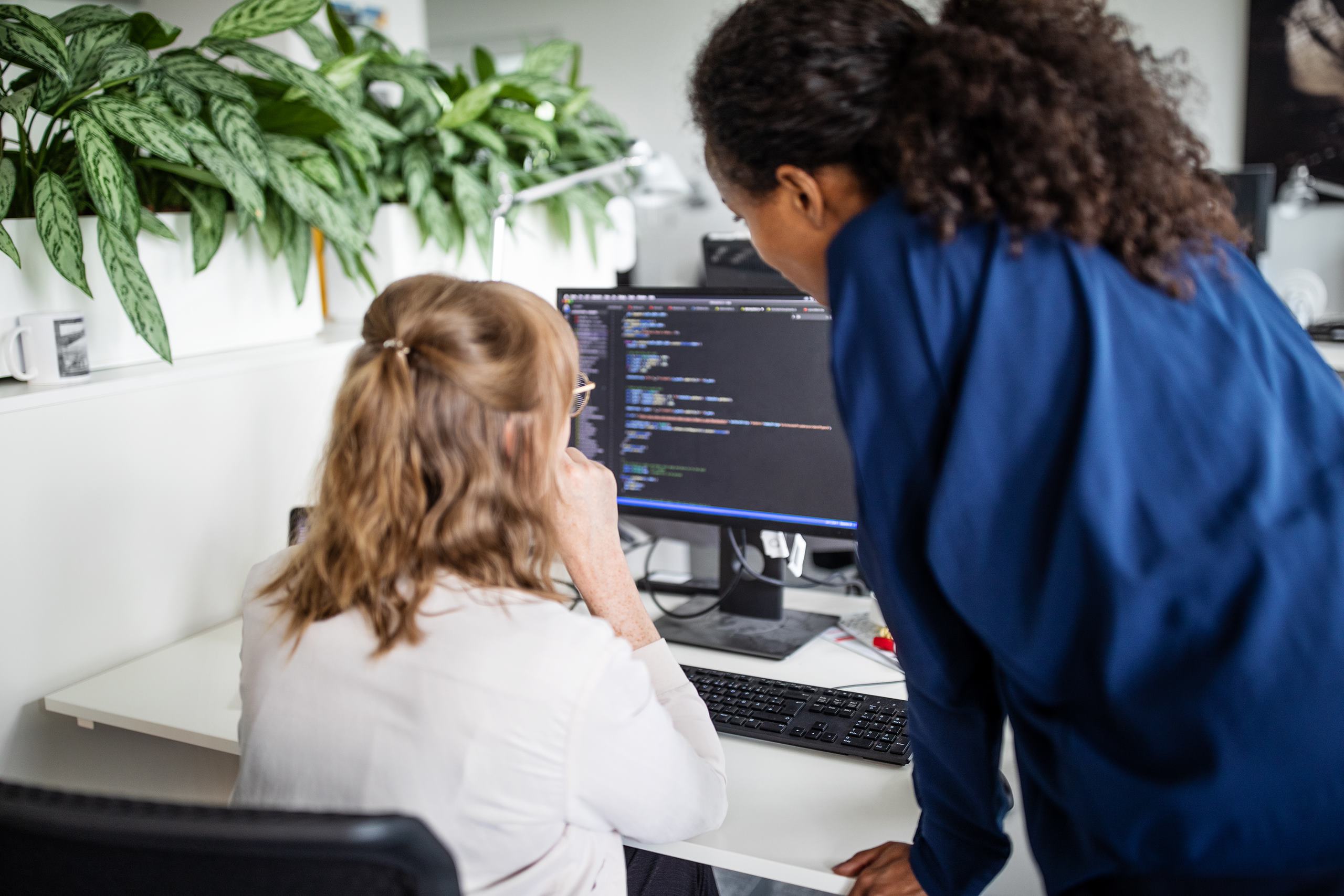 Women programming on computer