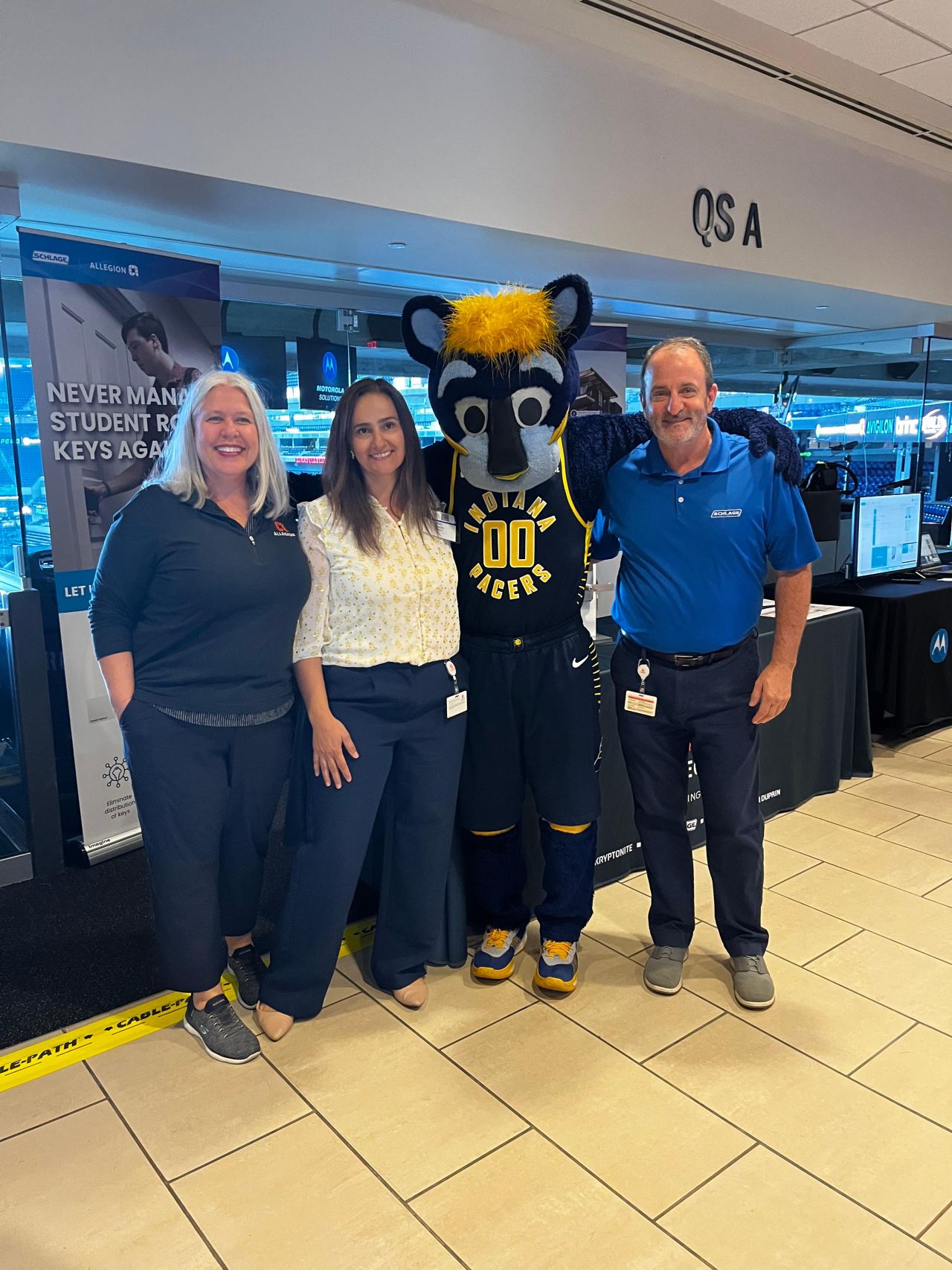 Allegion Americas poses with Boomer, the mascot of the Indiana Pacers, at the Motorola Solutions Tech Showcase.